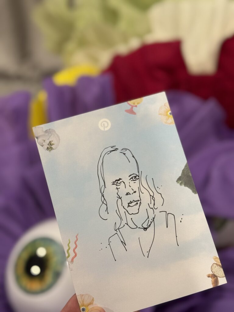 Surreal illustrator drawing quick portraits of guests during an immersive corporate summer party