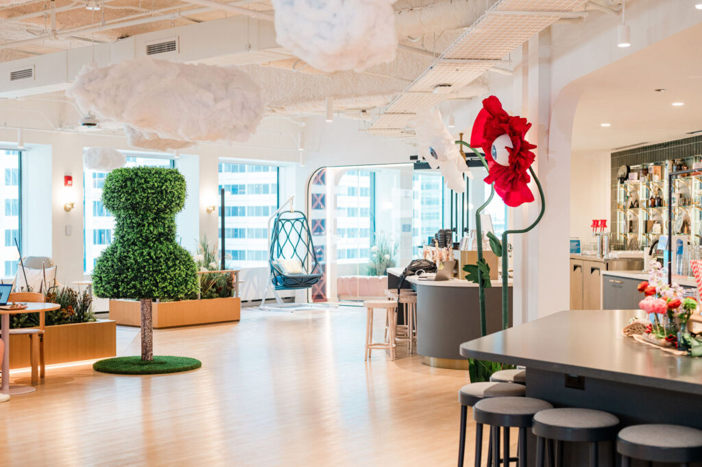 Cloud-suspended ceiling installation creating an airy, otherworldly atmosphere at a corporate summer celebration.