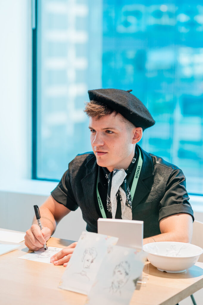 Surreal illustrator drawing quick portraits of guests during an immersive corporate summer party