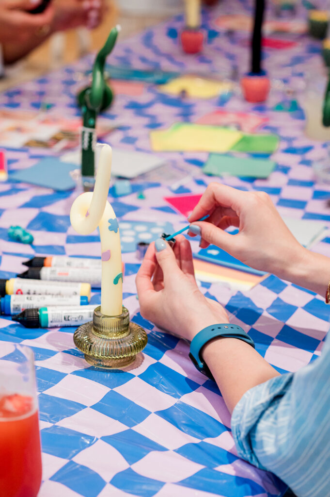 a womens hands decorating a candle